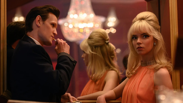 Anya Taylor-Joy as Sandie and Matt Smith as Jack, leaning against an ornate mirror in Last Night in Soho.
