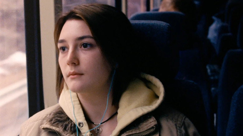 Sidney Flanigan as Autumn Callahan, staring out of a window with earbuds in in Never Rarely Sometimes Always.