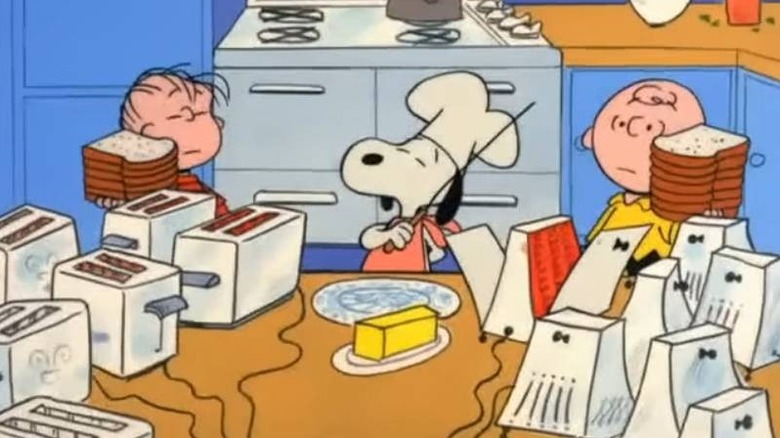 Linus, Snoopy, and Charlie making toast in A Charlie Brown Thanksgiving