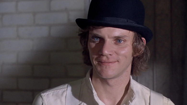 Malcolm McDowell as Alex DeLarge smiling in A Clockwork Orange