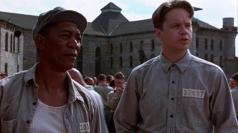 Tim Robbins and Morgan Freeman as Andy Drufense and Red talking in the prison yard in The Shawshank Redemption