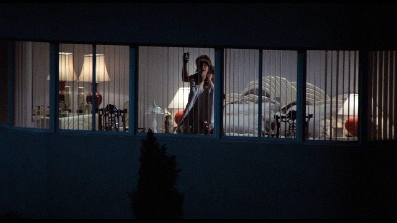 Deborah Shelton as Gloria Revelle in Body Double, as seen from across the way through her apartment window, being strangled by a killer.