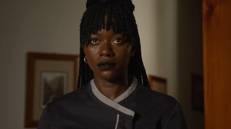 Babetida Sadjo as Marie standing with tears in her eyes in Our Father, the Devil