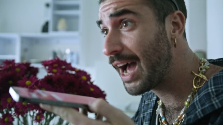 Jordan Firstman as Jordan Firstman speaking into a phone in Rotting in the Sun