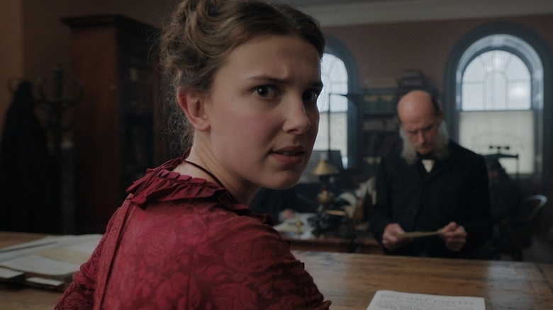 Millie Bobby Brown as Enola, breaking the fourth wall in Enola Holmes