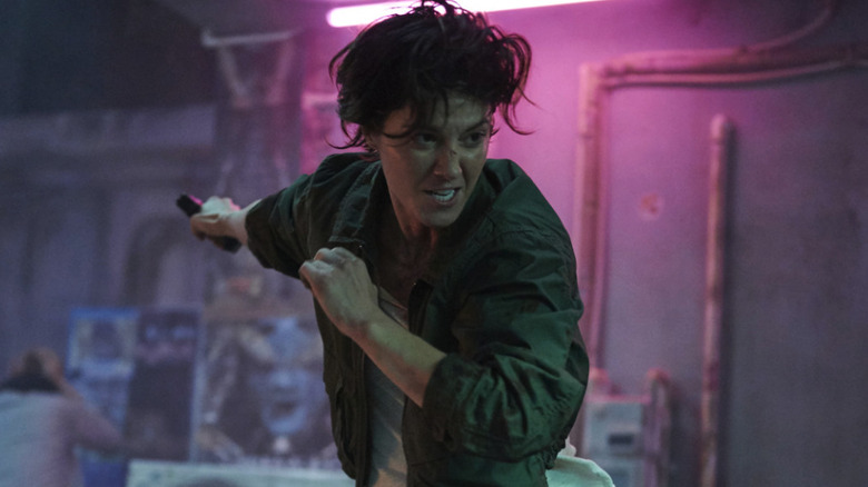 Mary Elizabeth Winstead as Kate, running with a gun in Kate