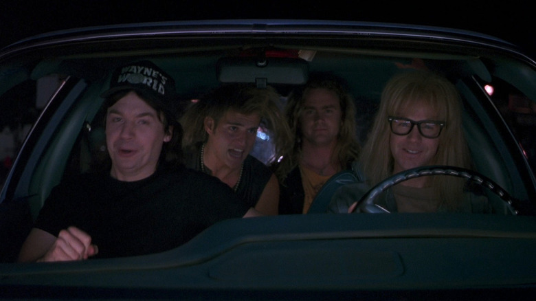 Dana Carvey as Garth sitting next to Mike Myers as Wayne in the Mirthmobile in Wayne's World