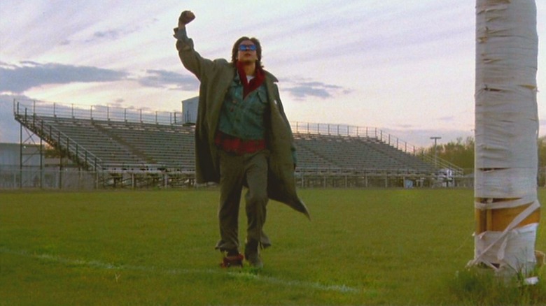 Judd Nelson as Bender raising his fist at the sky in a football field in The Breakfast Club