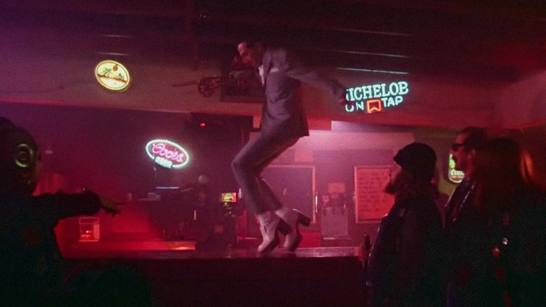 Paul Reubens as Pee-wee Herman dancing on a bar top in Pee-wee's Big Adventure