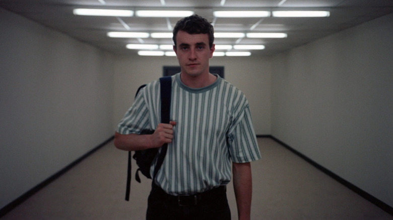 Paul Mescal as Calum standing in an airport hallway in Aftersun