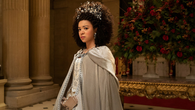 Queen Charlotte (India Amarteifio) looks apprehensively in an ornate room in Queen Charlotte: A Bridgerton Story