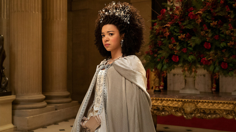 Queen Charlotte (India Amarteifio) looks apprehensively in an ornate room in Queen Charlotte: A Bridgerton Story