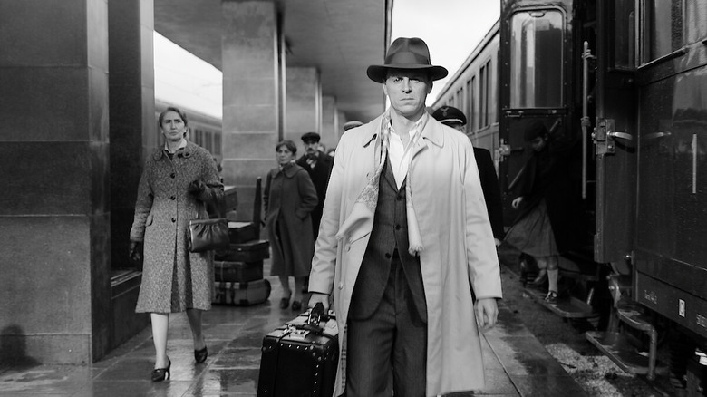 Tom Ripley (Andrew Scott) walks down a train platform in Ripley