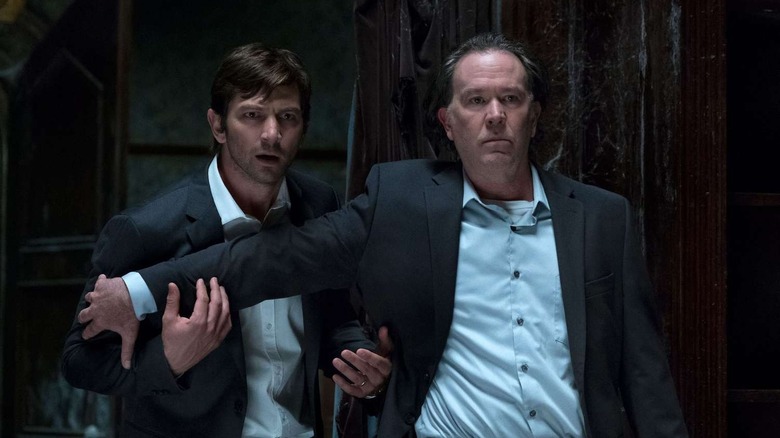 Hugh Crain (Timothy Hutton) holds back Steven Crain (Michiel Huisman) in The Haunting of Hill House