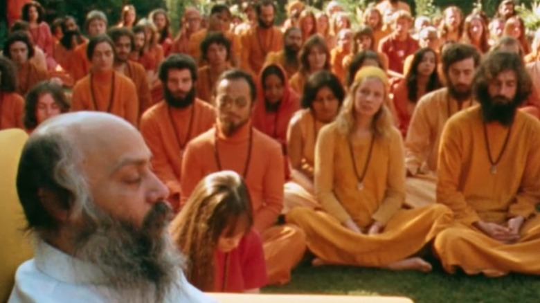 Bhagwan Shree Rajneesh leads his followers in meditation in Wild Wild Country
