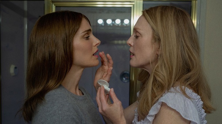 Julianne Moore as Gracie putting makeup on Natalie Portman as Elizabeth's lips in bathroom in May December