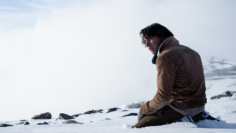 Enzo Vogrincic as Numa kneeling in the snow looking upset in Society of Snow