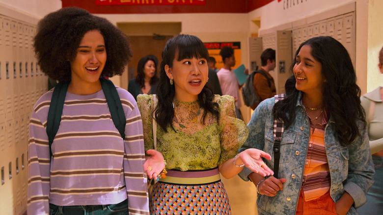 Lee Rodriguez as Fabiola, Ramona Young as Eleanor, and Maitreyi Ramakrishnan as Devi walking through a school hallway in Never Have I Ever