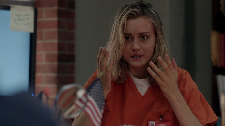Taylor Schilling as Piper holding her hands up in Orange is the New Black