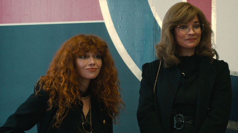 Natasha Lyonne as Nadia and Annie Murphy as young Ruth standing together in Russian Doll
