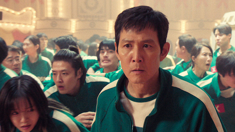 Lee Jung-jae as Seong looking afraid in a crowd in Squid Game
