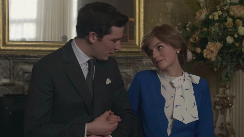 Josh O'Connor and Emma Corrin as Charles and Diana arm in arm in The Crown