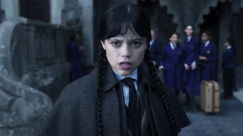 Jenna Ortega as Wednesday wearing a coat in Wednesday