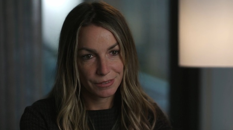 Karen Read smirking in front of a lamp, from A Body in the Snow: The Trial of Karen Read