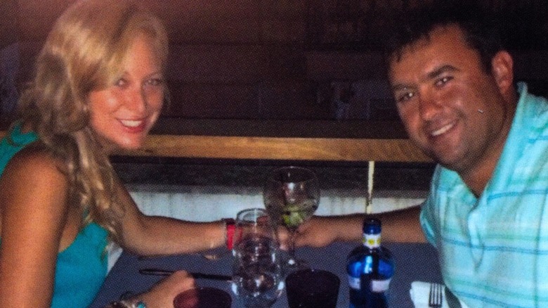 A photo of Jason and Molly Corbett at a dinner table covered in drinks, from A Deadly American Marriage
