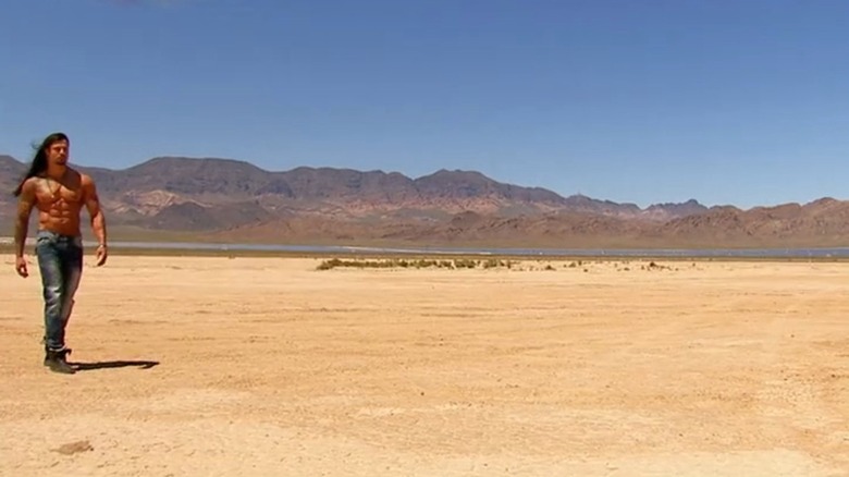 Ash Armand walking shirtless in the desert on Sin City Gigolo: A Murder in Las Vegas