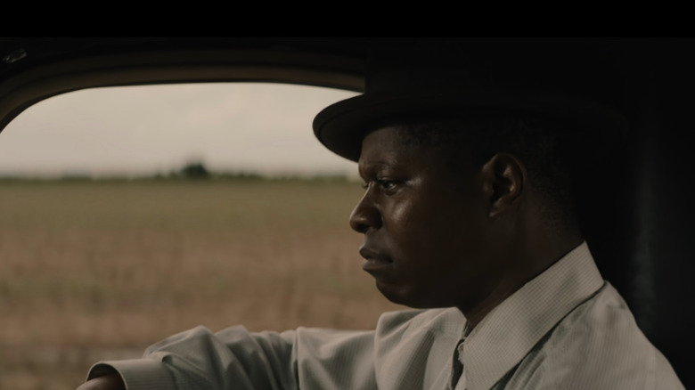 Ronsel (Jason Mitchell) melancholy in passenger seat in Mudbound