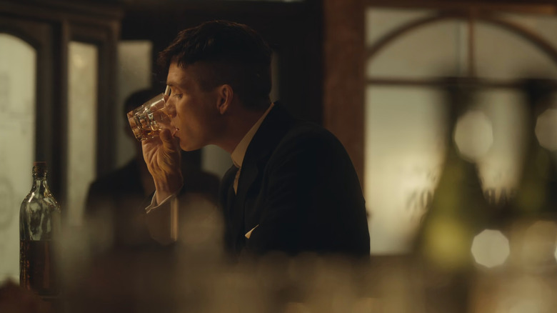 Tommy (Cillian Murphy) drinking in Peaky Blinders