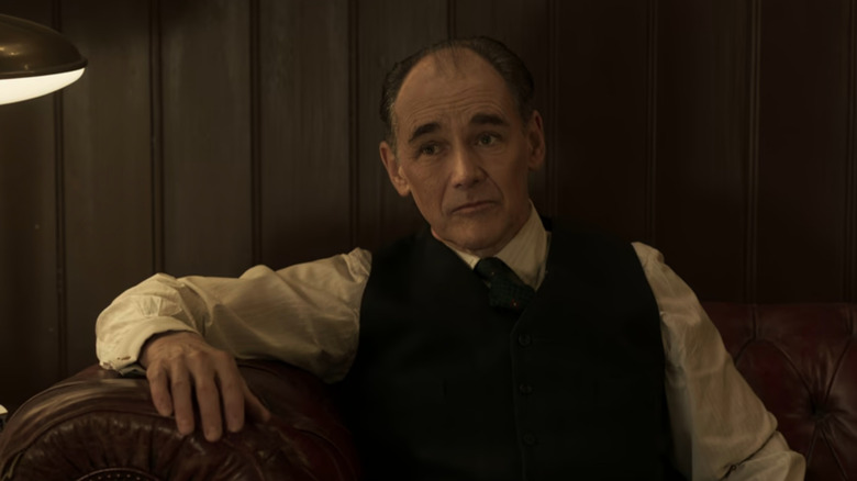 Leonard (Mark Rylance) sitting on couch in The Outfit