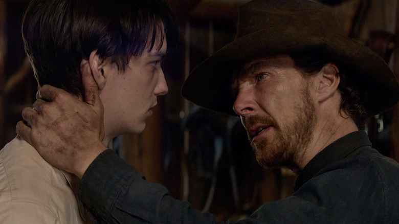 Phil (Benedict Cumberbatch) grabs Peter (Kodi Smit-McPhee) by the neck in The Power of the Dog