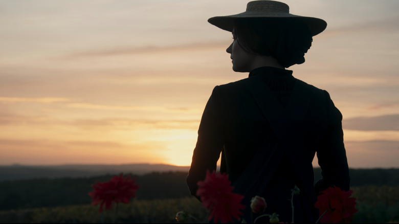 Clicquot (Haley Bennett) in field at sunset in Widow Clicquot
