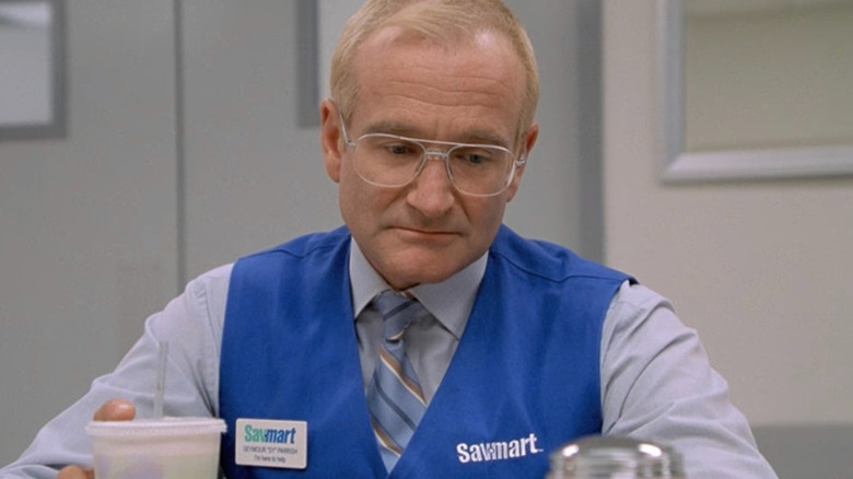Sy Parrish (Robin Williams) quietly sits with a drink in a break room in One Hour Photo