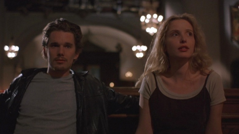 Ethan Hawke as Jesse and Julie Delpy as Céline sitting side by side in Before Sunrise