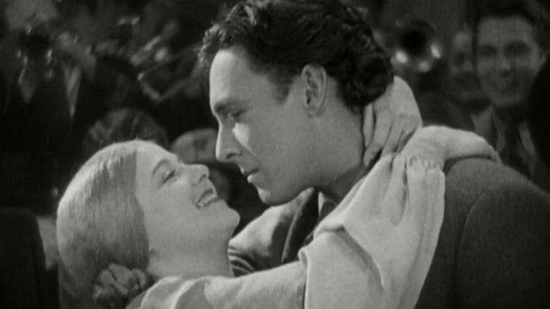 Janet Gaynor as the wife and George O'Brien as the man embracing and smiling at each other in Sunrise: A Song of Two Humans