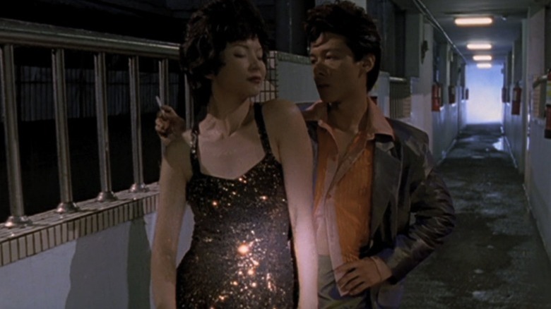 Yang Kuei-mei as the woman downstairs dancing with Lee Kang-sheng as the man upstairs in The Hole