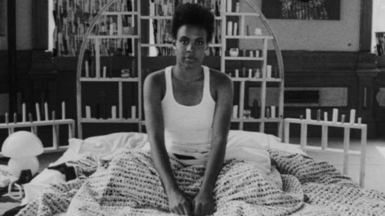 Tracy Camilla Johns as Nola Darling sitting up in bed in She's Gotta Have It