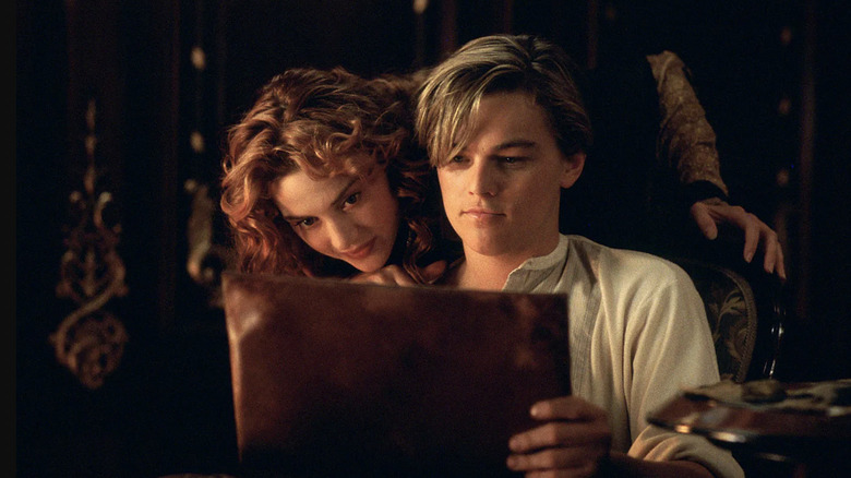 Kate Winslet as Rose DeWitt Bukater and Leonardo DiCaprio as Jack Dawson looking at Jack's drawing in Titanic