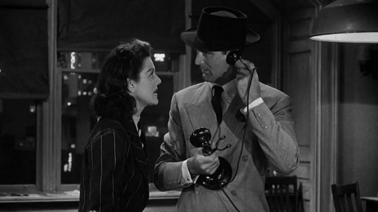 Rosalind Russell as Hildy Johnson speaking to Cary Grant as Walter Burns as he talks on the phone in His Girl Friday
