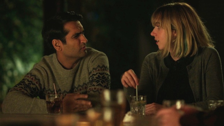 Kumail Nanjiani as Kumail and Zoe Kazan as Emily chatting at a bar counter in The Big Sick