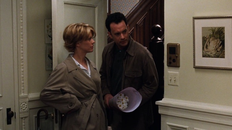 Meg Ryan as Kathleen Kelly and Tom Hanks as Joe Fox standing at the entrance to an apartment in You've Got Mail