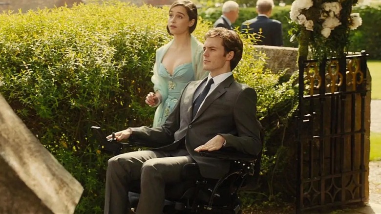 Emilia Clarke as Louisa Clark stands next to Sam Claflin as William Traynor while outside in Me Before You