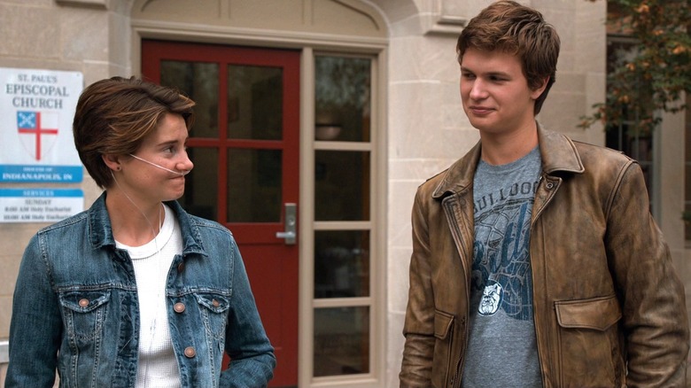 Shailene Woodley as Hazel stands outside a church with Ansel Elgort as Gus in The Fault in Our Stars
