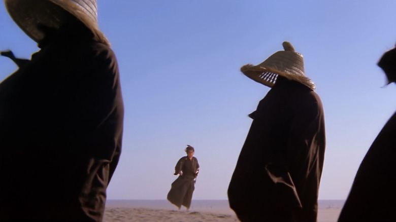 Ogami Ittō (Tomisaburō Wakayama) approaches three warriors wearing straw hats in Lone Wolf and Cub: Baby Cart at the River Styx