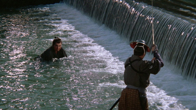 Ogami Ittō (Tomisaburō Wakayama) wades through water to a swordsman in Lone Wolf and Cub: Sword of Vengeance