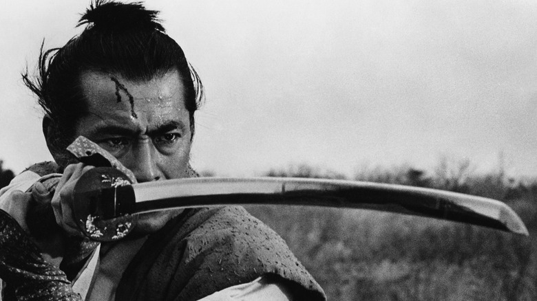 Isaburo Sasahara (Toshiro Mifune) stands sweaty and bloody with his sword drawn in Samurai Rebellion