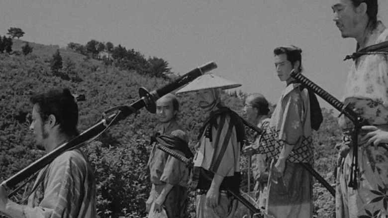 The seven samurai walk together down a hill in Seven Samurai